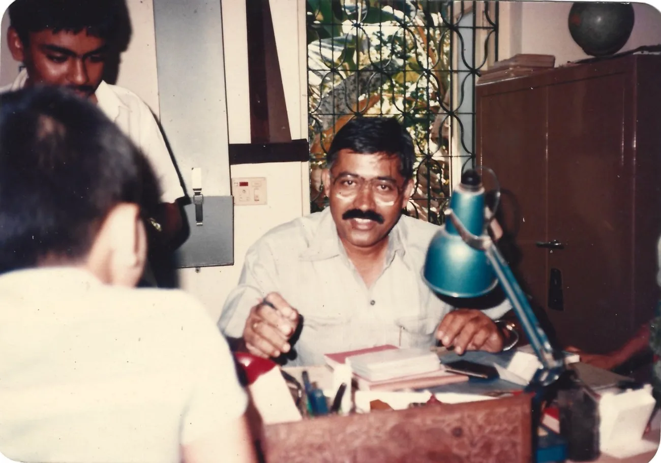 The founder at his office desk